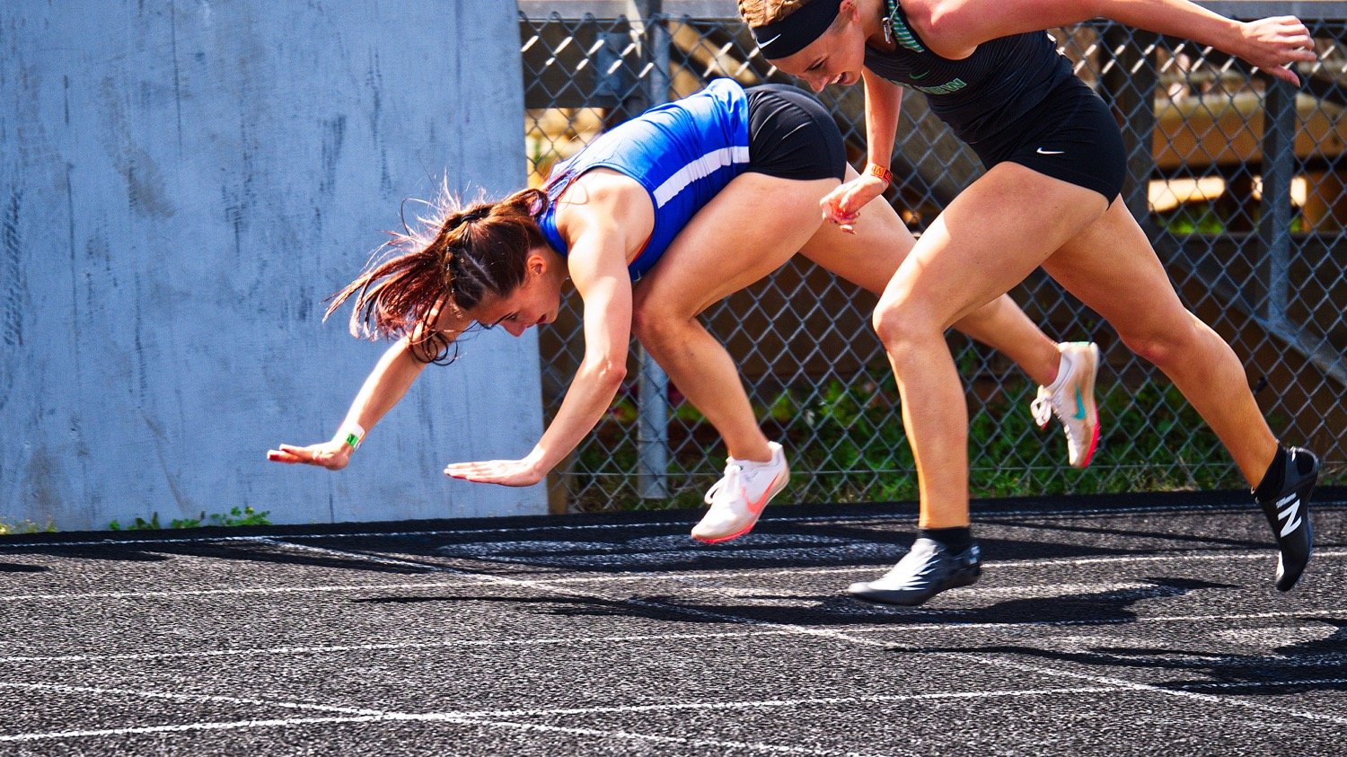Quitman hurdler Brooklyn Marcee dives over the finish line to edge out Valley View's Rylee Gattenby for second place by one one-hundredth of a second in the 300 meter hurdles. [view more valiant efforts]